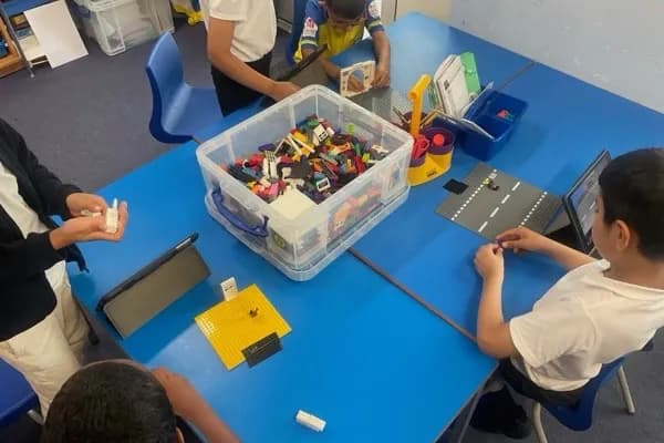 Students building LEGO sets and choosing props for their stop-motion animation films