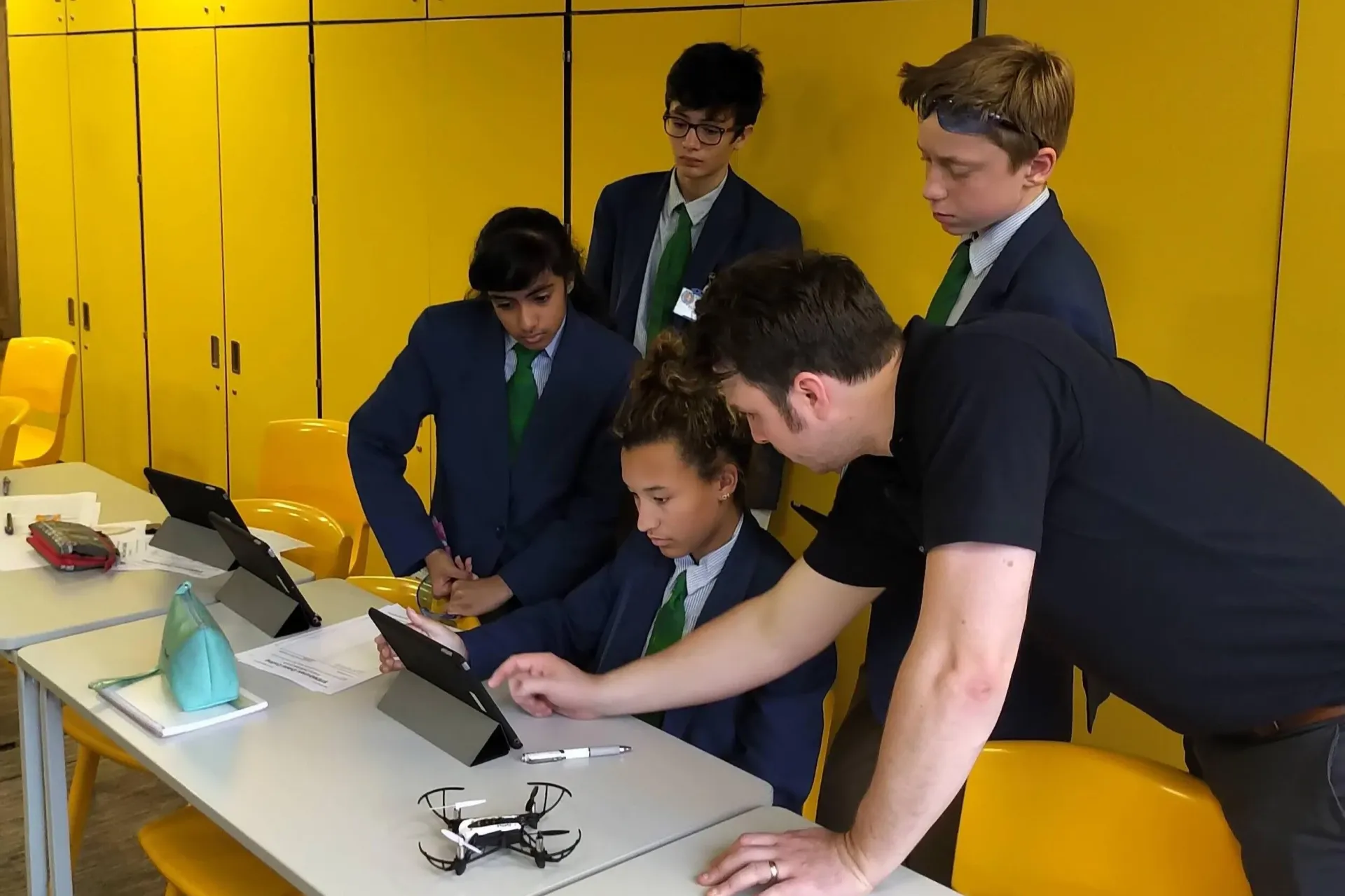 Students programming drones in a coding workshop