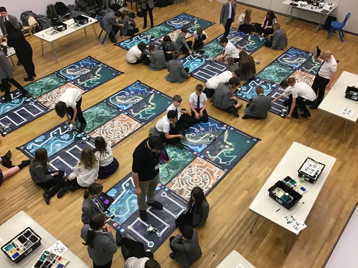 Students working with robotics equipment during an in-school STEM workshop