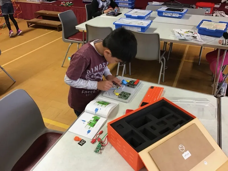 Boy working with a Raspberry Pi computing kit at a Tech Tigers session