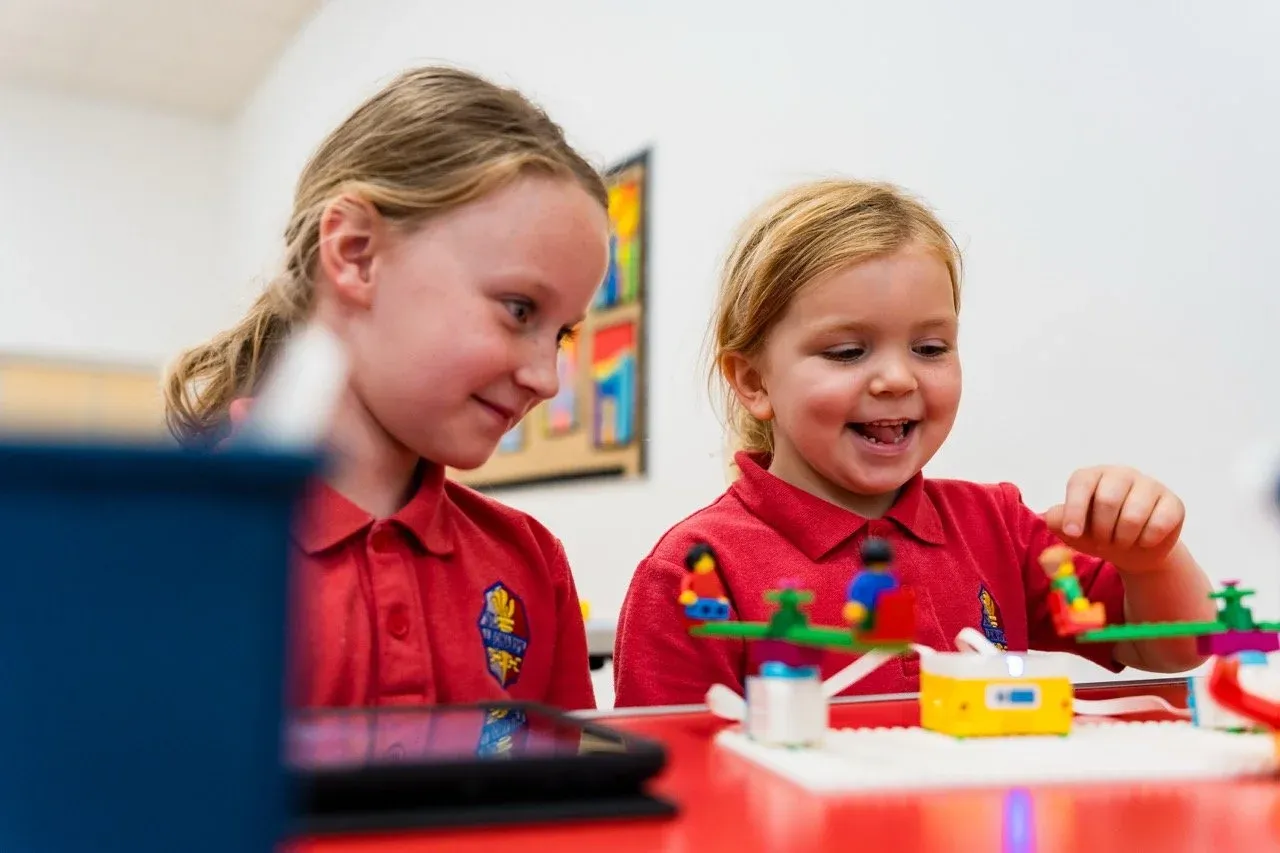 Primary school students building and programming robots during a STEM workshop