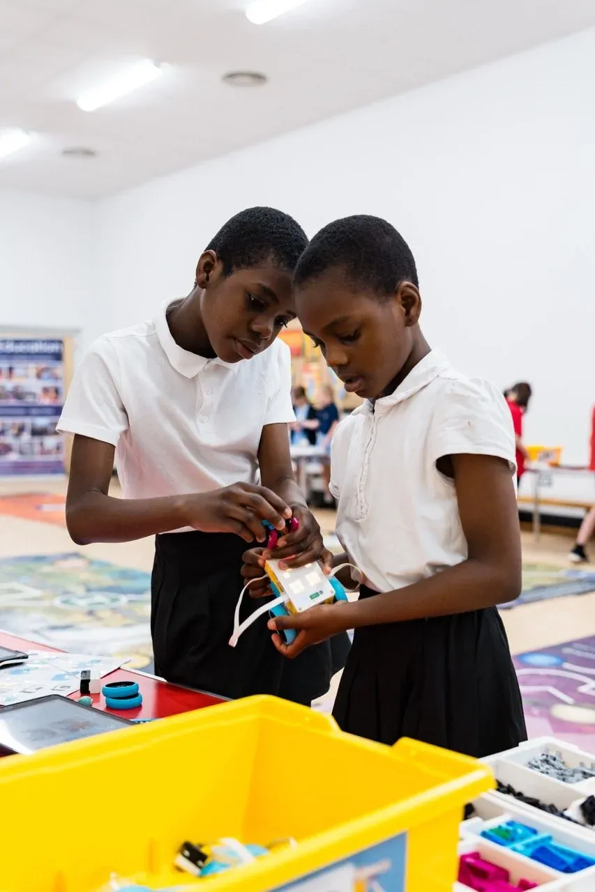 Students programming intermediate robots during a STEMbotics workshop