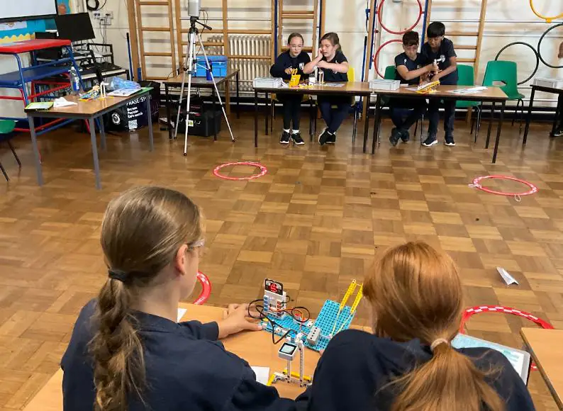Pupils testing an AI paper aeroplane launcher