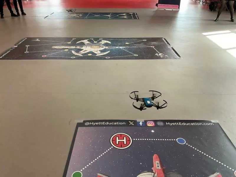 A coded drone mid-flight during a challenge