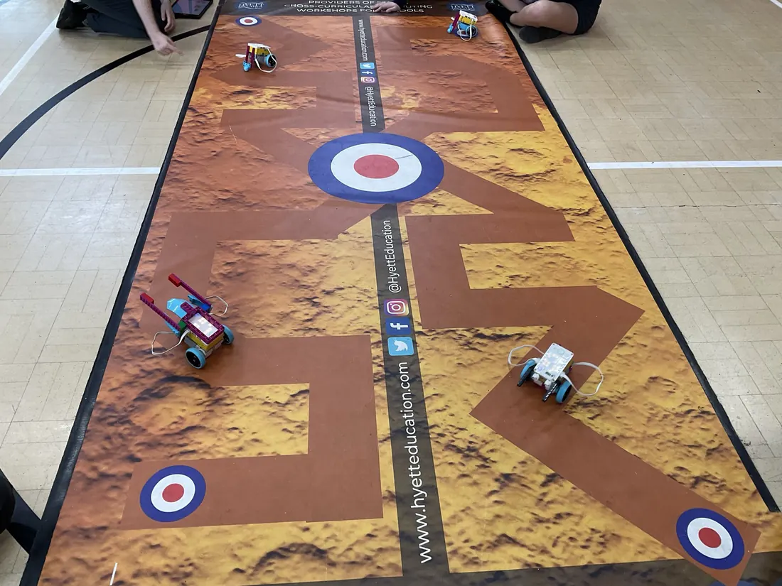 Robots on a challenge mat marked with RAF roundels