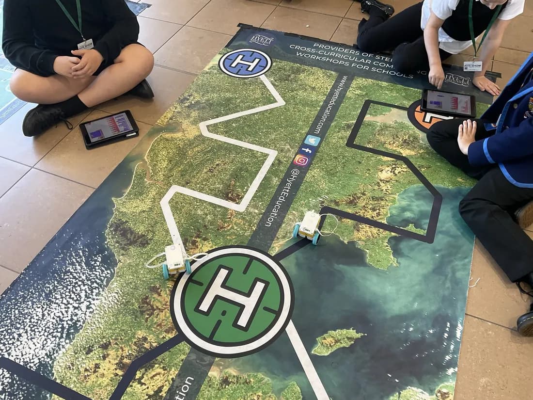 Coded robots on a map challenge mat at Glasgow Prestwick Airport