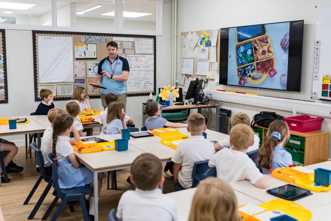 Primary pupils coding robots in a classroom workshop