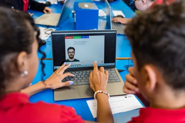Students using the encrypt and decrypt tool on a laptop during a cryptography workshop