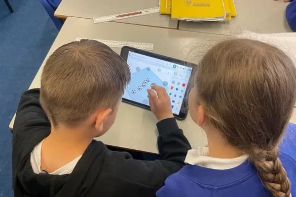 Two children using TinkerCAD 3D design software on a tablet during a design workshop