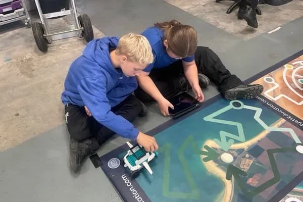 Students programming a SPIKE robot on the Hyett Education mission mat at UTC Plymouth