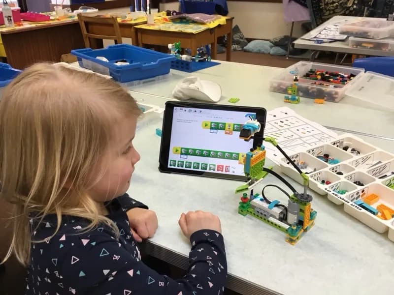Girl programming a robot with an iPad at a Tech Tigers club session