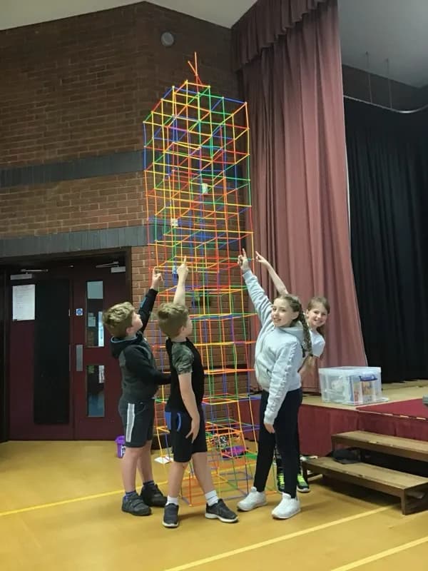 Children working together to build a giant tower at a Tech Tigers holiday club