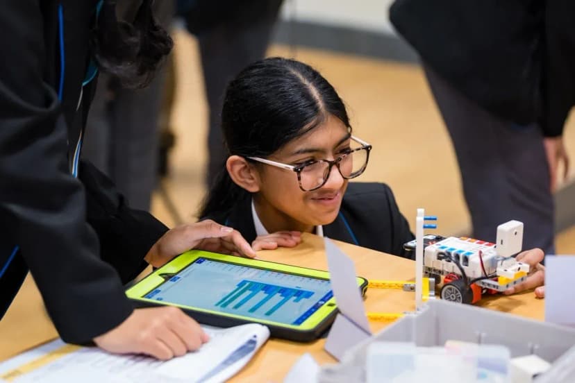 Girls taking part in a STEM workshop with robotics equipment